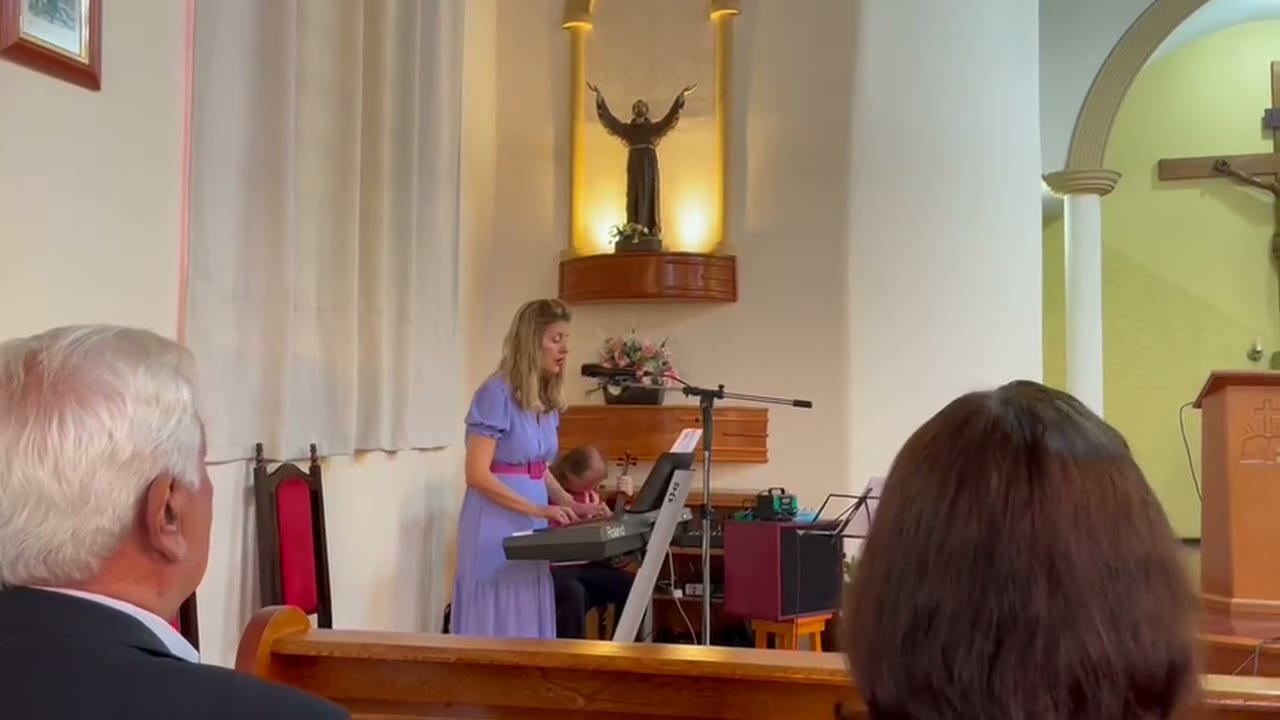 A student playing the piano in church.
